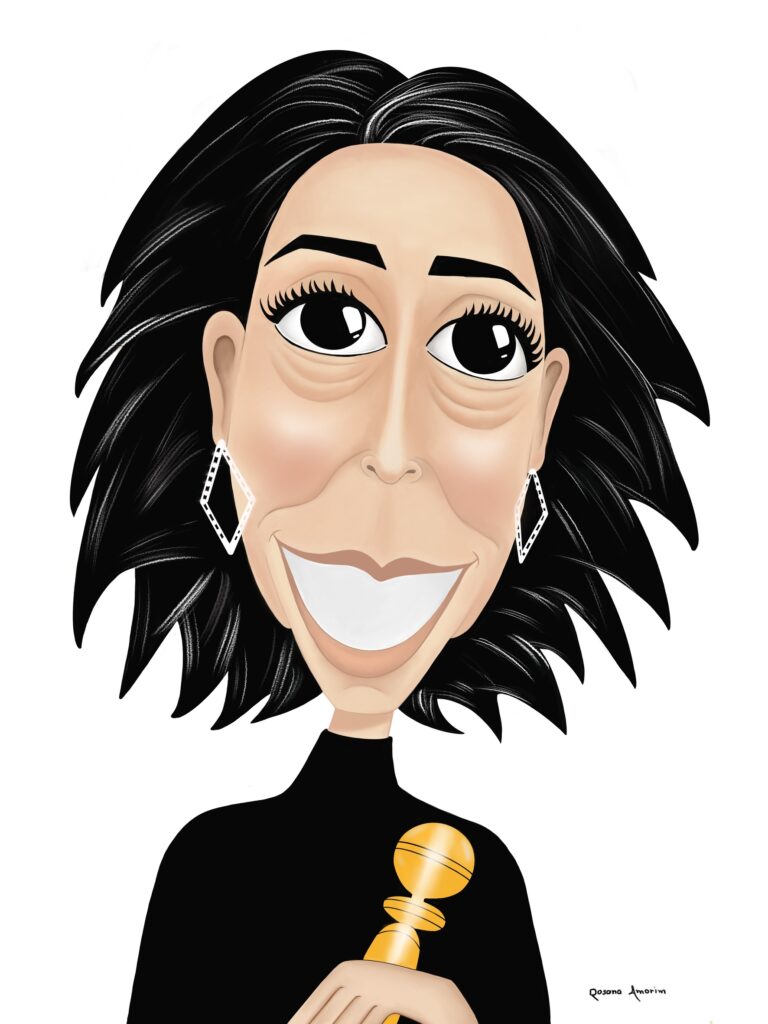 Caricatura da atriz Fernanda Torres, com traços exagerados, grandes olhos expressivos e um largo sorriso. Ela veste roupa preta, usa brincos brilhantes e segura um Oscar dourado nas mãos. O fundo é branco, destacando sua fisionomia e cabelo preto volumoso. A ilustração é assinada pela artista Rosana Amorim.