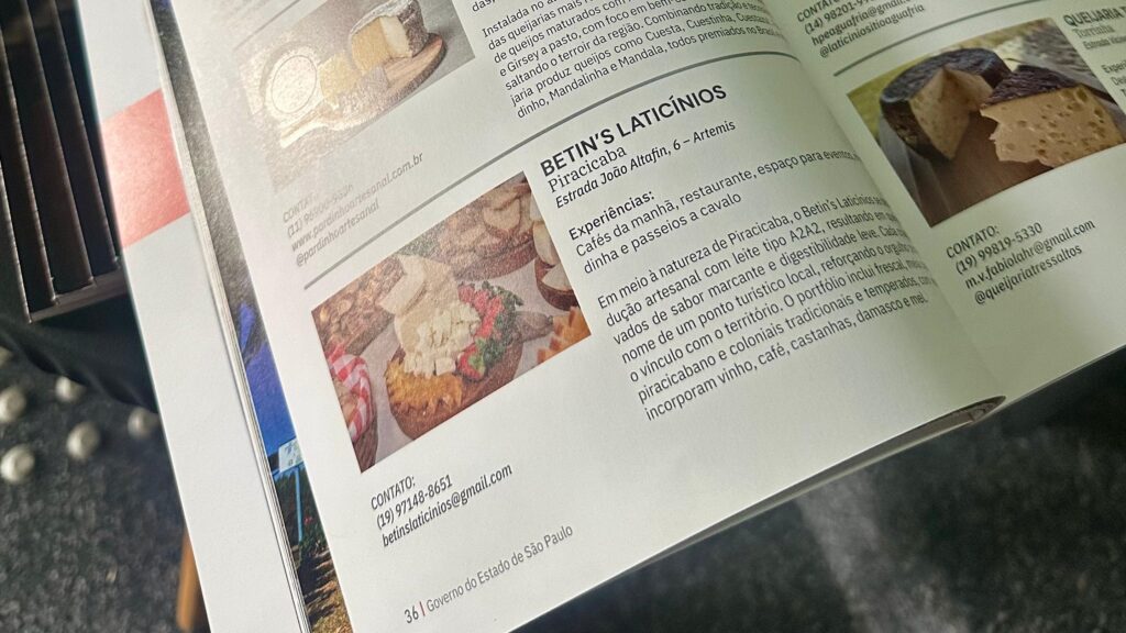 A imagem mostra uma página de uma revista ou folheto turístico, com foco em produtos lácteos e turismo rural. Há várias seções com informações sobre diferentes estabelecimentos. Em destaque, há uma seção sobre "BETIN'S LATICÍNIOS" em Piracicaba, com o endereço "Estrada João Altafin, 6 - Artemis". Esta seção descreve as experiências oferecidas, como cafés da manhã, restaurante, espaço para eventos, "dinhã" (possivelmente uma refeição típica ou degustação) e passeios a cavalo. O texto também detalha a produção artesanal de queijos com leite tipo A2A2, destacando o sabor marcante, a digestibilidade leve e o vínculo com o território. O portfólio inclui queijos frescais, piracicabanos e coloniais, com temperos como vinho, café, castanhas, damasco e mel. Informações de contato como telefone (19) 97148-8651, e-mail betinslaticinios@gmail.com e o número da página (36) são visíveis.