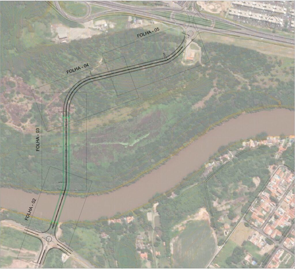 Na imagem aérea aparece um rio rodeado por vegetação verde. Abaixo a direita aparecem algumas residências.