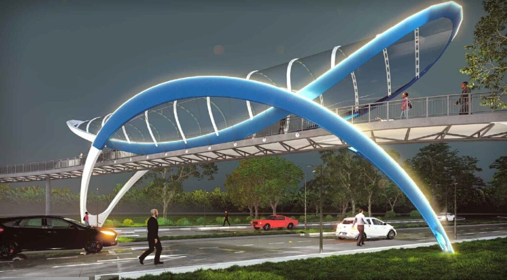 A imagem mostra uma ponte para pedestres futurista iluminada à noite. A estrutura da ponte tem um design curvo e moderno, com arcos azuis iluminados que se cruzam, parecendo uma hélice de DNA ou uma escultura abstrata. A passarela é transparente e protegida, permitindo que as pessoas atravessem com segurança sobre a via abaixo. No chão, há uma estrada com alguns carros trafegando, incluindo um SUV preto em primeiro plano, um carro esportivo vermelho e um carro branco mais ao fundo. Algumas pessoas estão caminhando tanto na ponte quanto na calçada próxima, incluindo um homem vestido de terno escuro na frente. O ambiente ao redor tem árvores e postes de iluminação, e o céu está escuro, indicando que é noite ou crepúsculo. A iluminação azul vibrante da ponte contrasta com o céu escuro, destacando a estrutura de forma impressionante e moderna.