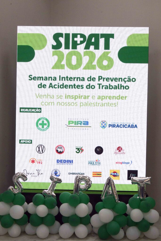 Painel da SIPAT 2026 (Semana Interna de Prevenção de Acidentes do Trabalho), decorado com balões verdes e brancos e logotipos de instituições apoiadoras.